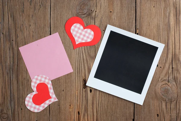 Instant photo with blank note and hearts — Stock Photo, Image
