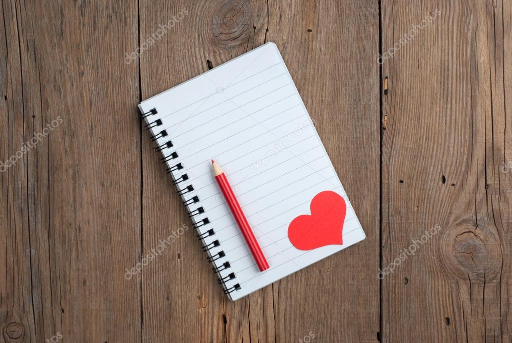 Notebook with hearts and pencil