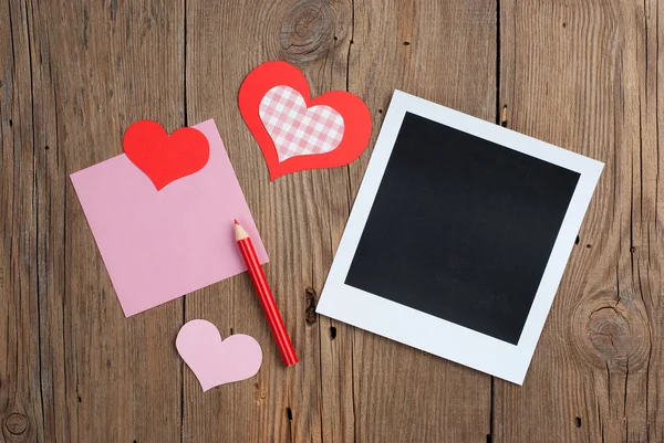 Instant photo with blank note, pencil and hearts — Stock Photo, Image