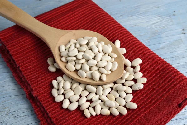 Wooden spoon with white beans — Stock Photo, Image