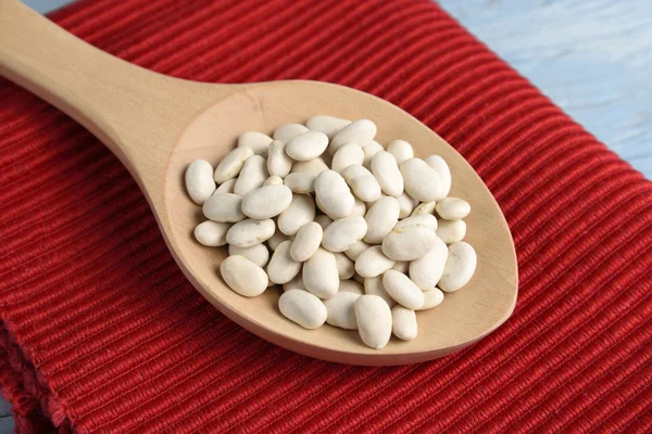 Wooden spoon with white beans — Stock Photo, Image