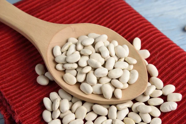 Wooden spoon with white beans — Stock Photo, Image