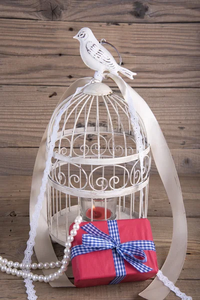 Bird cage and gift box — Stock Photo, Image