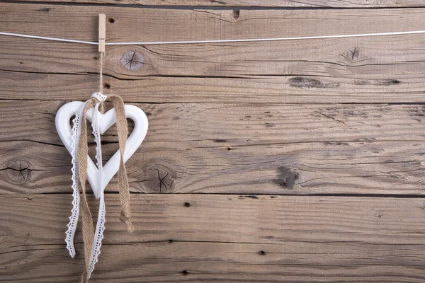 Wooden heart decoration with ribbons — Stock Photo, Image