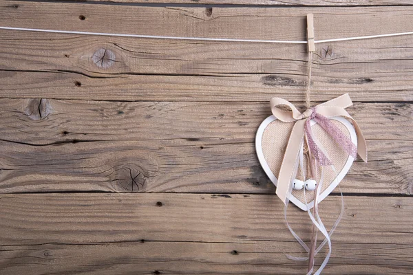 Wooden heart decoration with ribbons — Stock Photo, Image