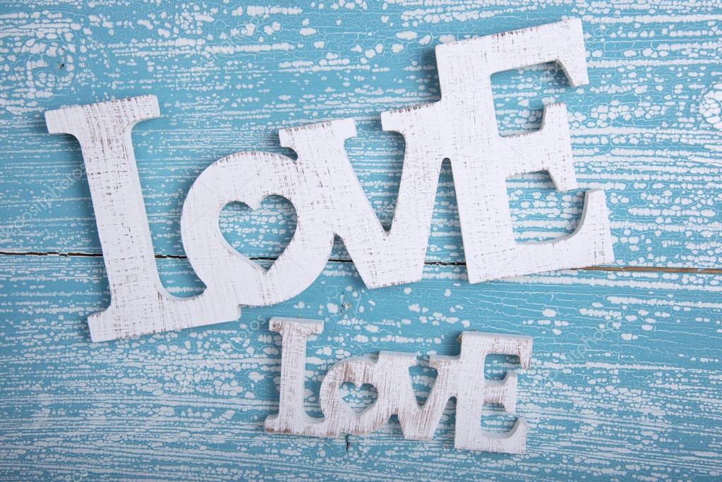 Word LOVE on old wooden background