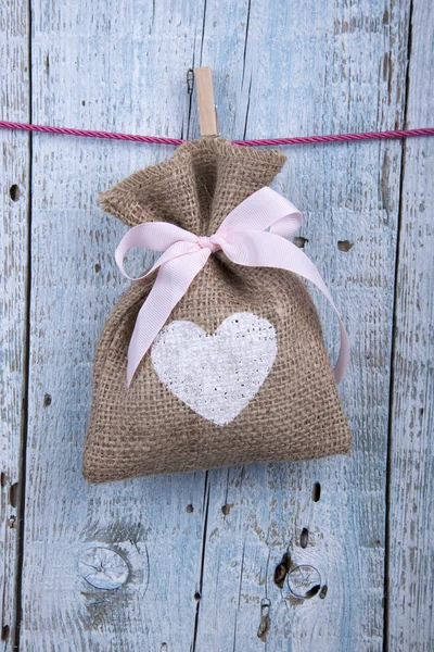 Burlap pouch hanging on clothesline — Stock Photo, Image