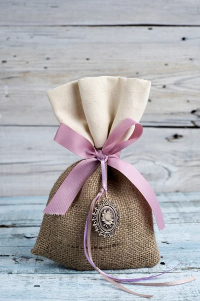 Burlap pouch tied with ribbon — Stock Photo, Image