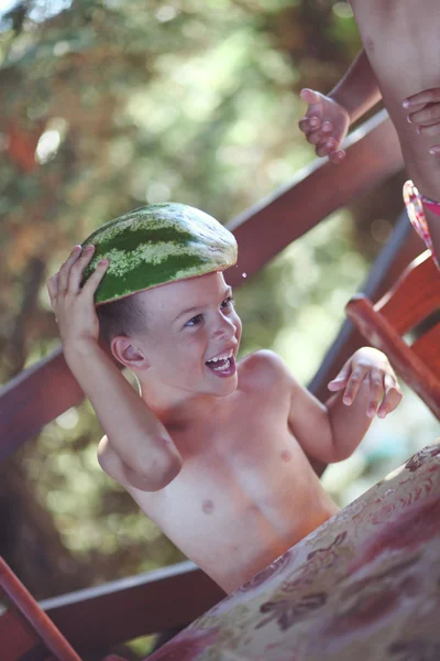 Boy holding watermelon as hat and laughing a big time — Stock Photo, Image