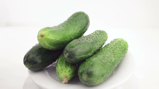 Cucumbers on a white plate rotate — Stock Video