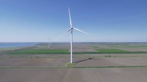 Wind turbine in the countryside in summer sunny day under clear sky — Stock Video