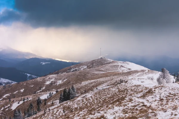 Sunset in winter mountains with dramatic light — Stock Photo, Image