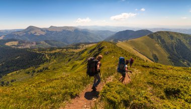 bir grup insan ile yolda yürüyen sırt çantaları.