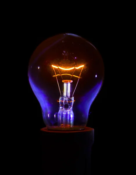 Glowing light bulb with detailed filament and inner glass body. — Stock Photo, Image