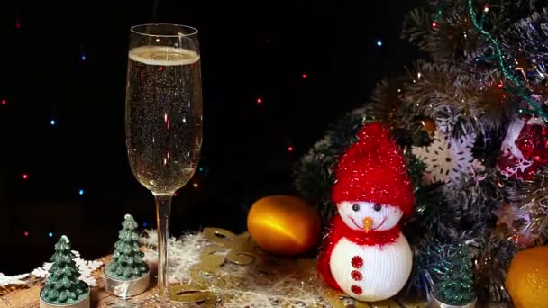 Burbujas dentro de una copa de champán sobre el fondo de las luces navideñas — Vídeos de Stock