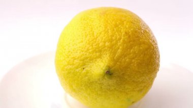 Sarı limon kendi üzerinde beyaz bir arka plan üzerinde dönüm
