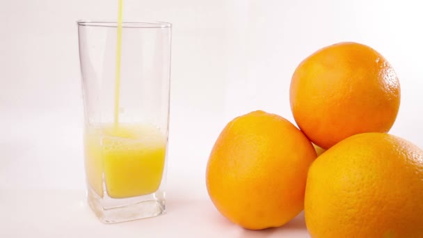 Orange juice pouring into glass — Stock Video