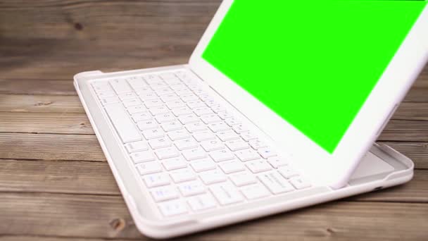 Un uomo tira su un portatile sulla scrivania. Schermo verde per il contenuto dello schermo personalizzato — Video Stock