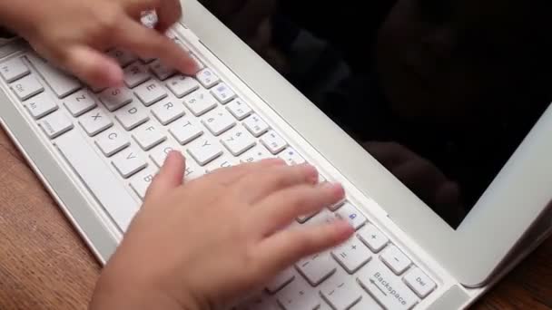 Руки маленької дитини, що друкується на клавіатурі — стокове відео