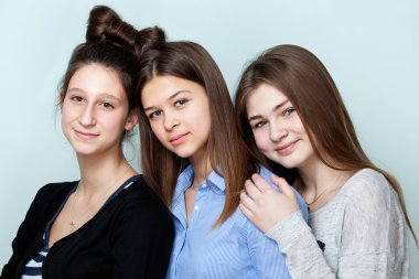 Portrait of three teenage girls smiling clipart