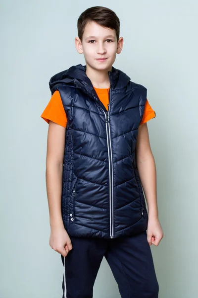 Portrait of a brunette boy in a sports vest and pants — Stock Photo, Image