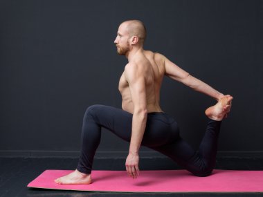 Young man  is doing front lunge