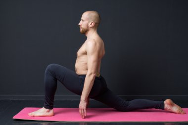 Young man  is doing front lunge
