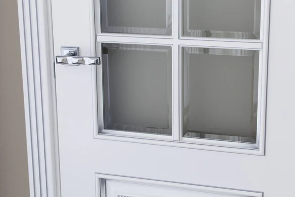 A part of a white door with glass windows — Stock Photo, Image