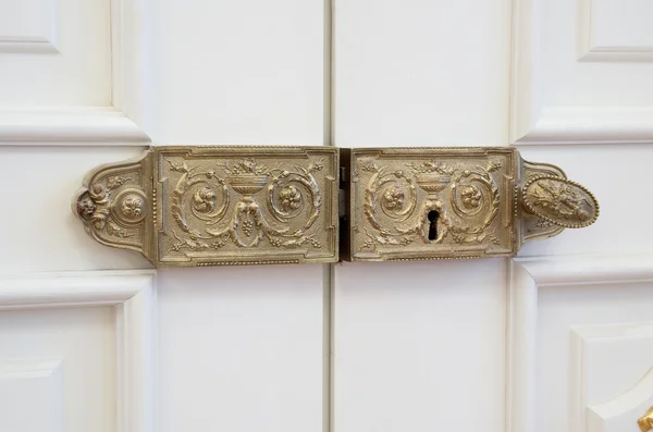 Vintage gilded ancient lock on the white door — Stock Photo, Image
