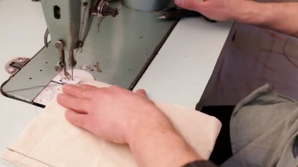 Man hands sews the fabric — Stock Video