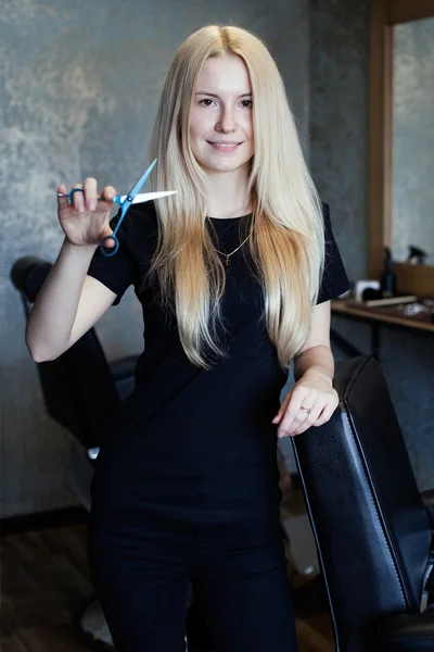 Portrait of a young beautiful  woman barber