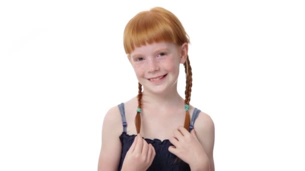 Close up little ginger girl is coquettishly touch her pigtail — Vídeo de stock