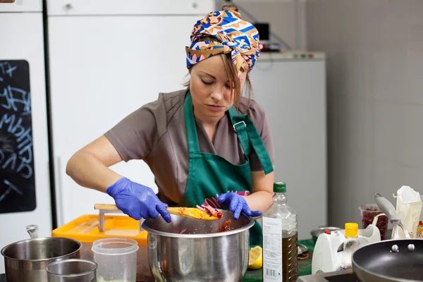 Woman cook preparing food in the pan