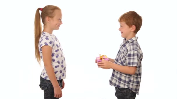 Little boy giving a present to the gir — Stock Video