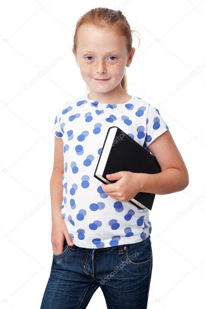 Little girl holding book and smiling