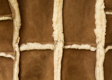 two peaces of  sheepskin are sewn together clipart