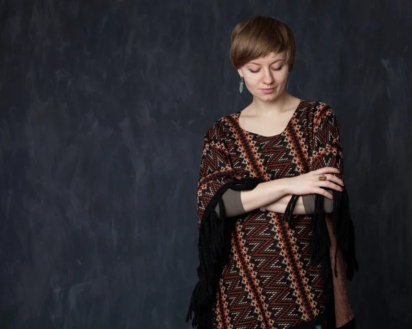 Junge schöne Dame im Poncho schaut nach unten — Stockfoto