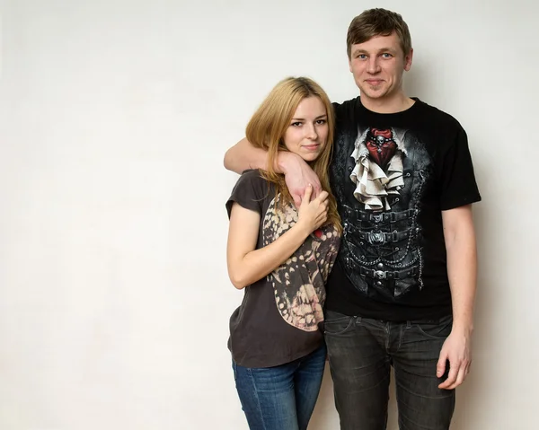 Yong couple against the white wall — Stock Photo, Image