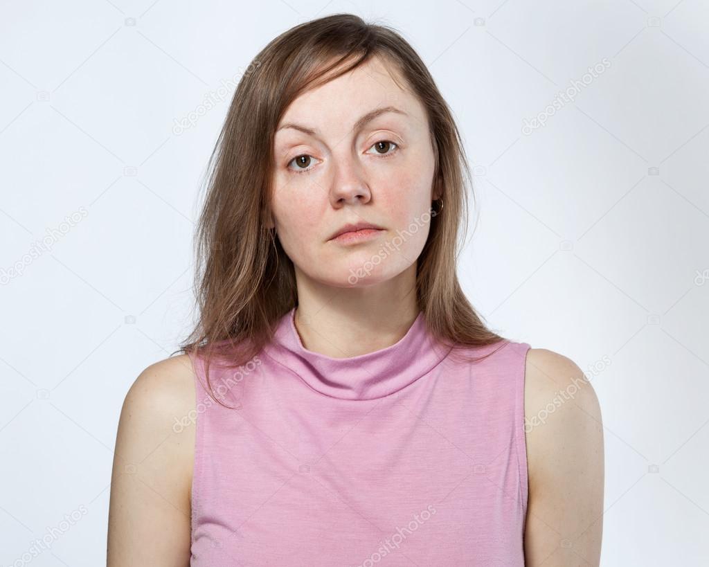 Portrait of a sad woman in a pink shirt