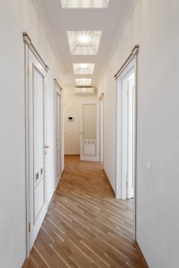 White coridor  with doors, in the apartment