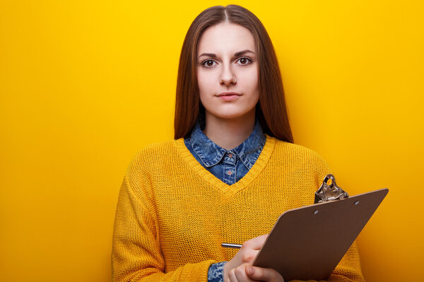 Portrait of attractive girl with clipboard