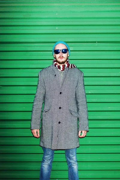 Male hipster in a coat and sunglasses — Stock Photo, Image