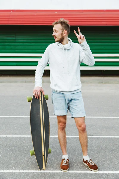 Hipster giovane con longboard — Foto Stock
