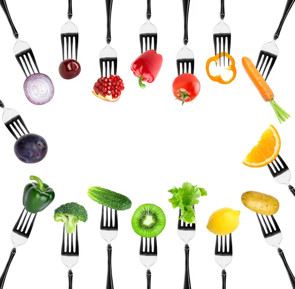 Fruits and vegetables on fork — Stock Photo, Image