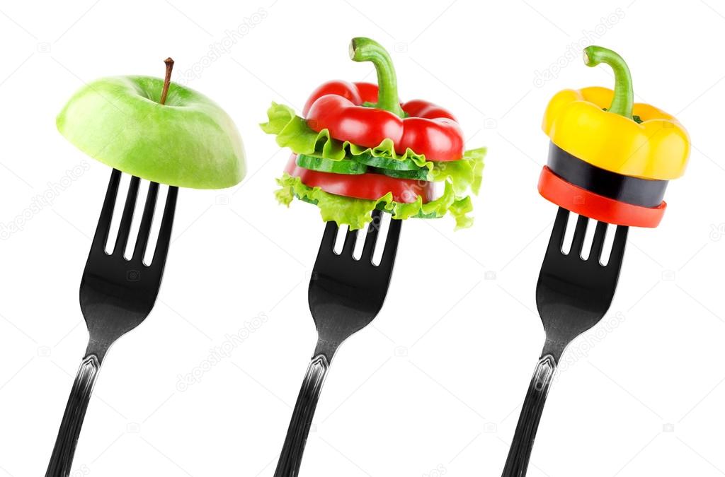 Fruit and vegetable slices on fork