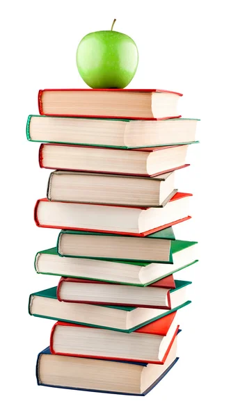 Knihy zásobník s zelené jablko na vrcholu — Stock fotografie