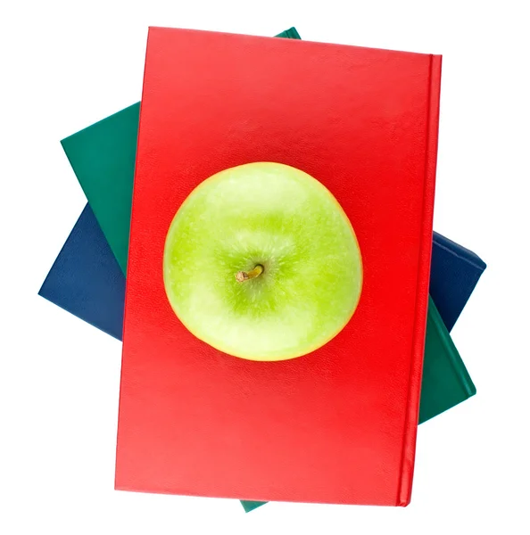 Drei Farbbücher und grüner Apfelblick von oben — Stockfoto