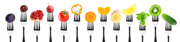 Fruits and vegetables on fork — Stock Photo, Image