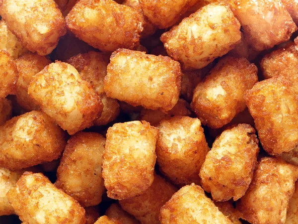Rustic golden potato tater tots food background — Stock Photo, Image