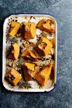 Bir tepsi rustik altın fırınlanmış balkabağı.